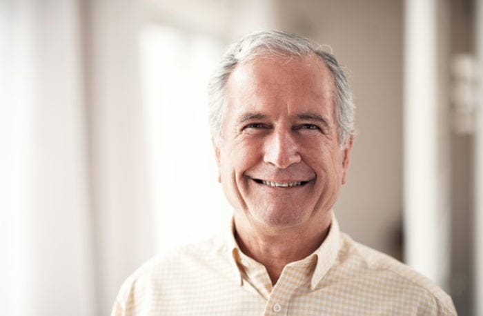 Middle-aged man smiling.