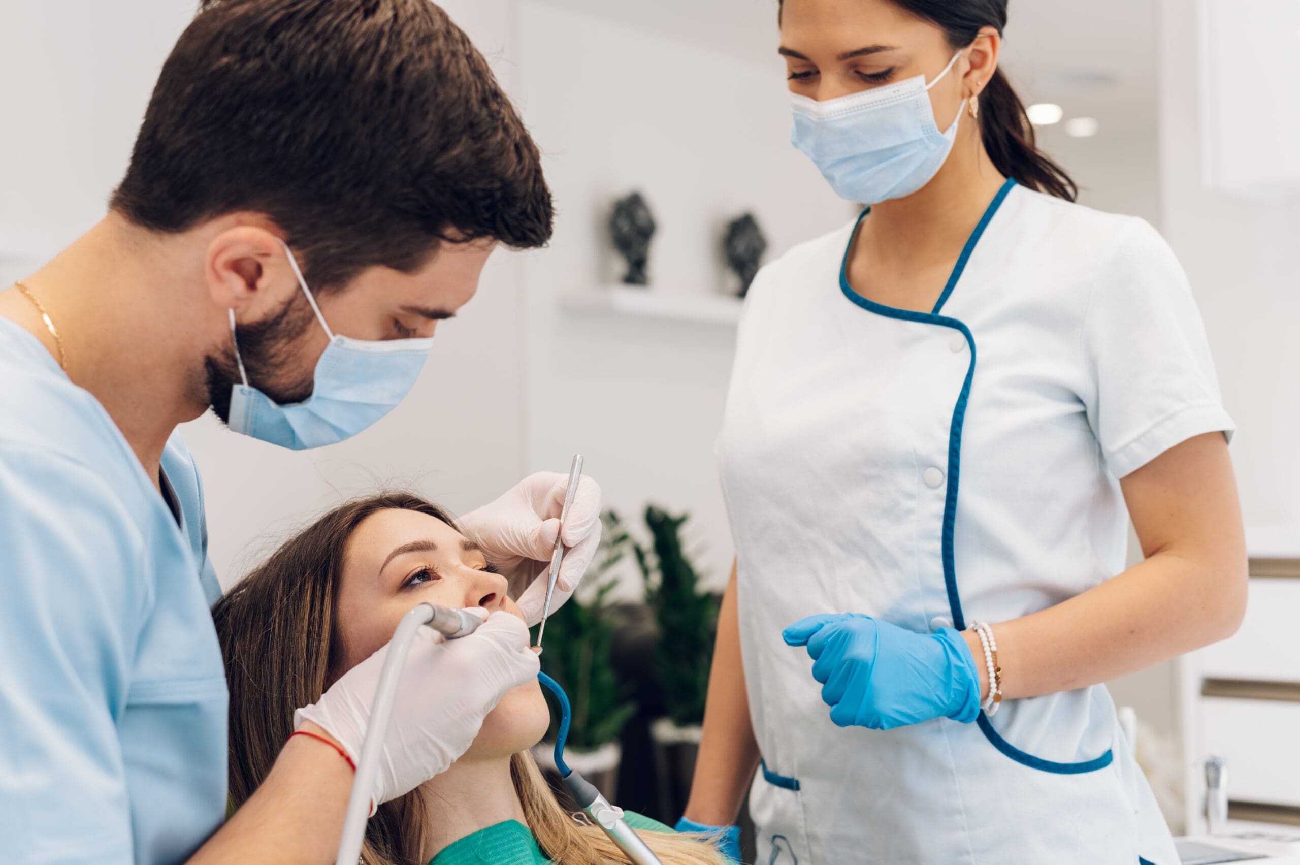 A female patient being examined by a male dentist in a dental clinic at Sudbury Dental Arts.