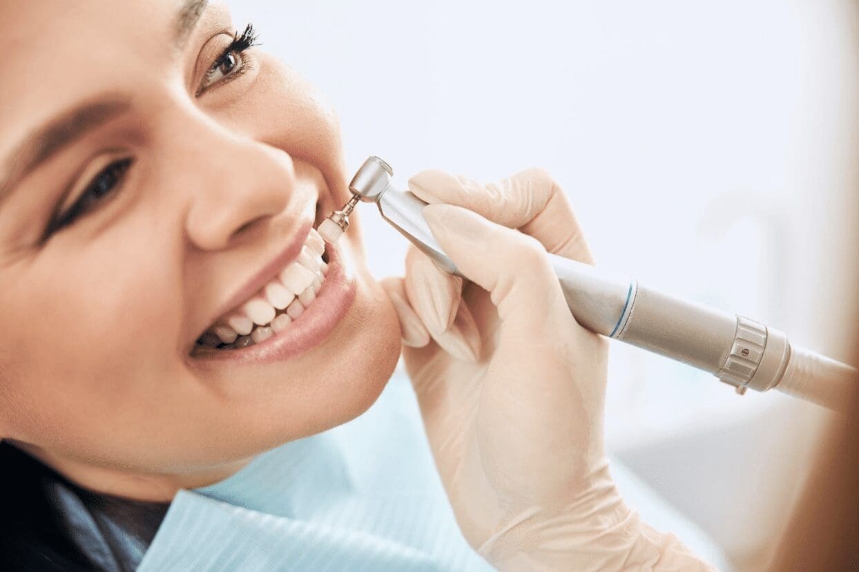 A patient receiving teeth cleaning treatment at Sudbury Dental Arts.