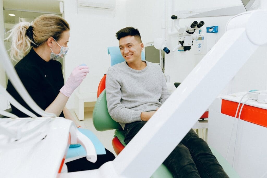 Dentist discussing treatment options with a patient in the dental chair at Sudbury Dental Arts.