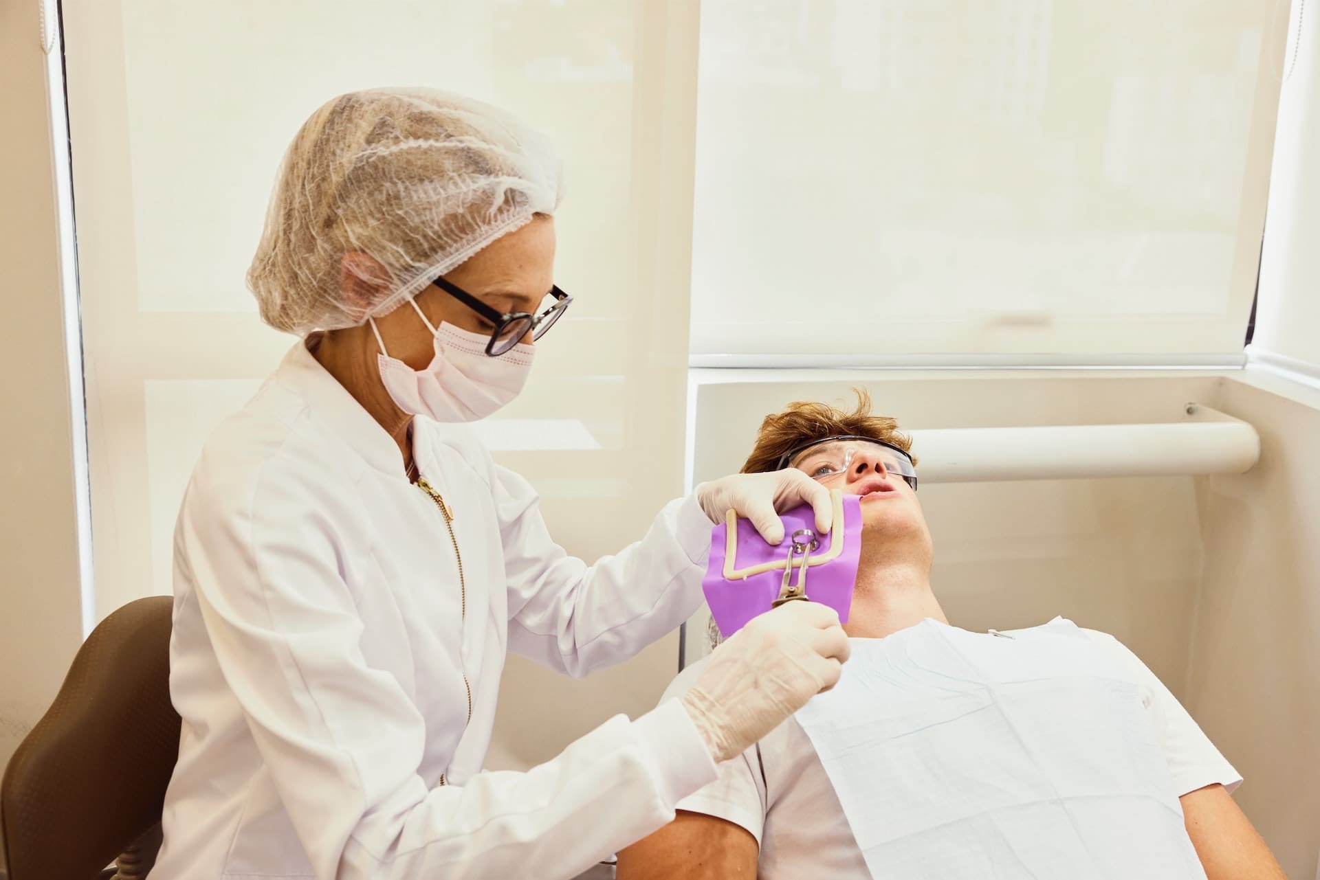 A dentist preparing to place a dental crown for a patient at Sudbury Dental Arts.