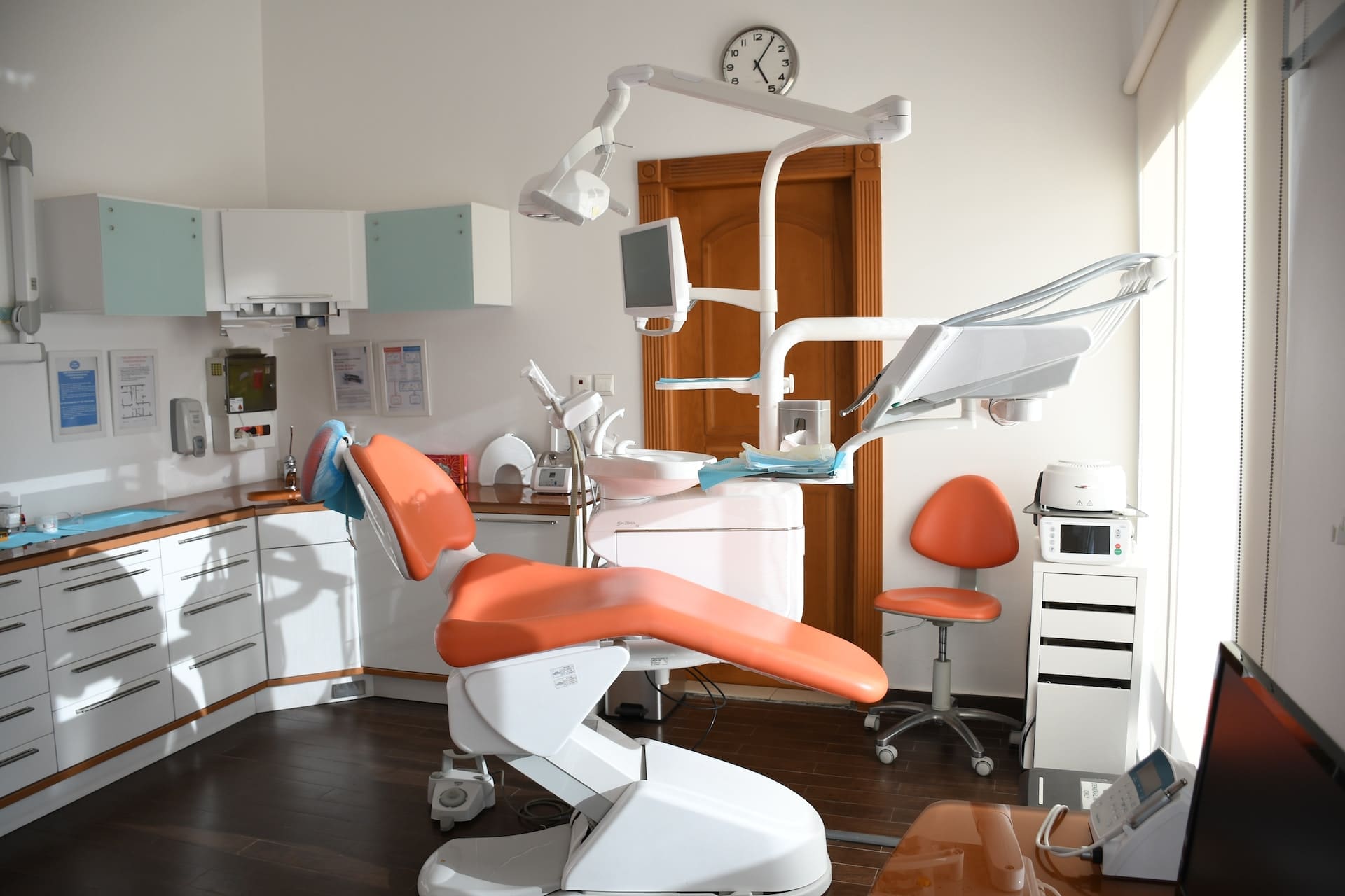 Interior of a modern dental office with clean, bright surroundings, dental chairs, and equipment.