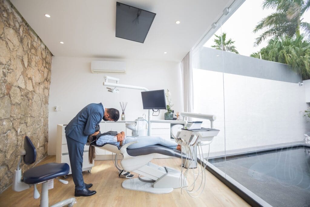 Dentist explaining to a patient why they should never put their tooth extraction on hold at Sudbury Dental Arts in Sudbury, MA 01776.