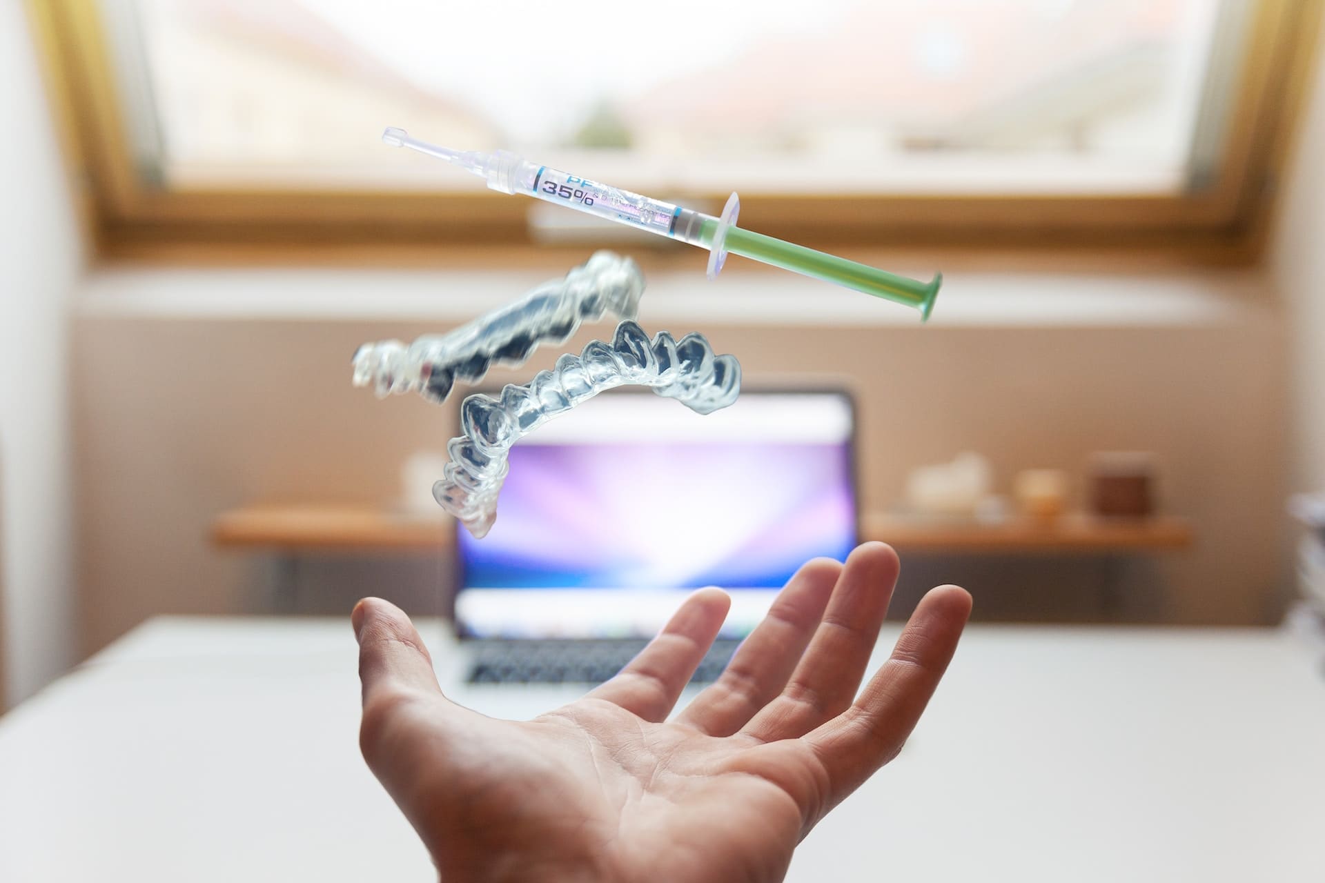 An image displaying both Invisalign clear aligners and a dental syringe, representing orthodontic treatment and dental procedures.