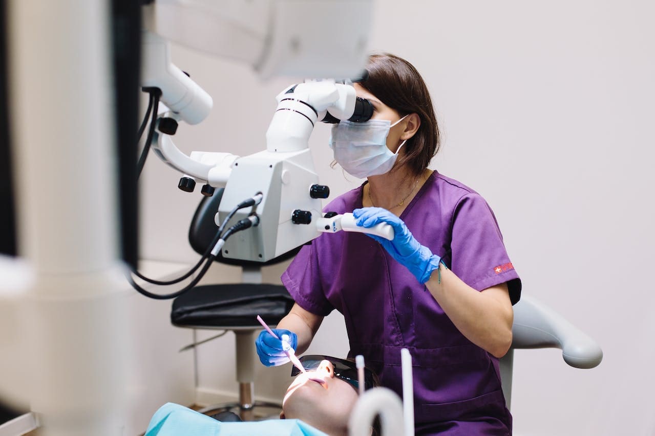 A dentist at Sudbury Dental using a diagnostic machine to check a customer's oral health.